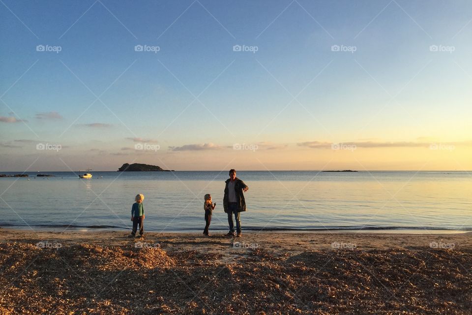 Family on the beach at sunset