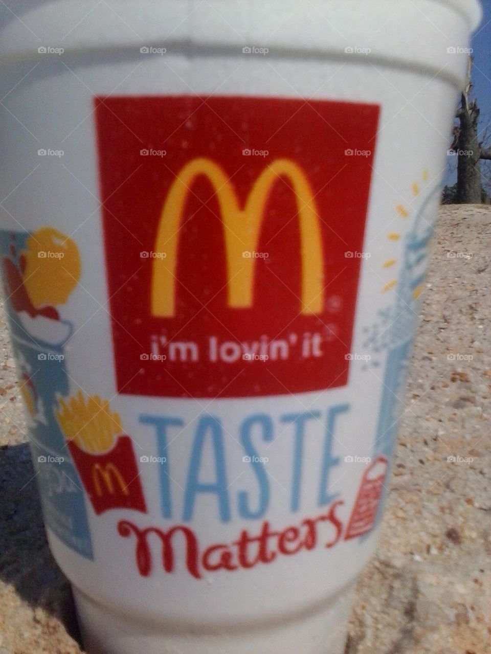 McDonalds cup in the sand