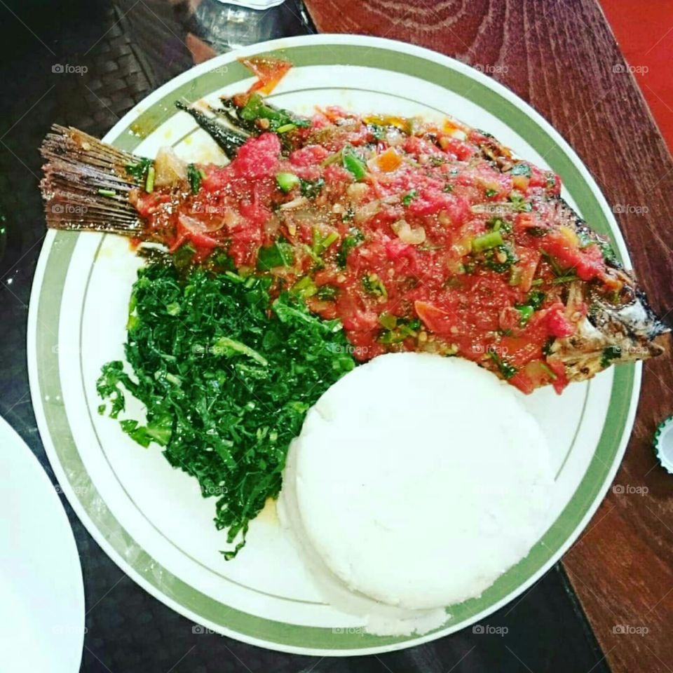 Ugali,Sukuma wiki and Fish -Kenya tasty favourite meal.