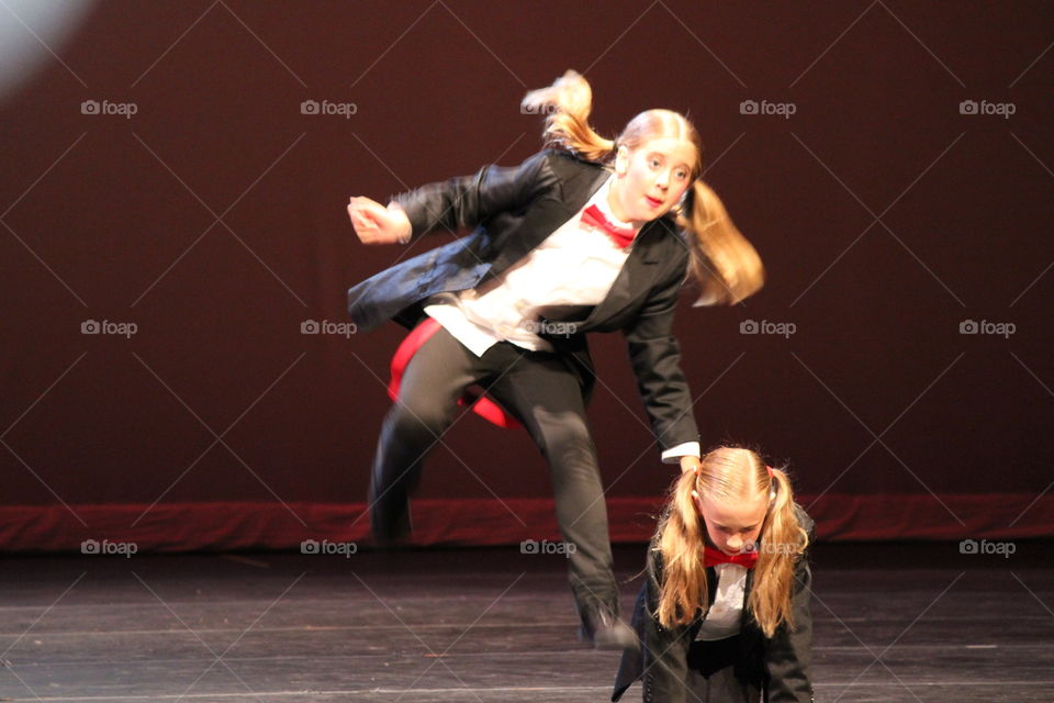 Everybody jump. Girl jumping at dance recital