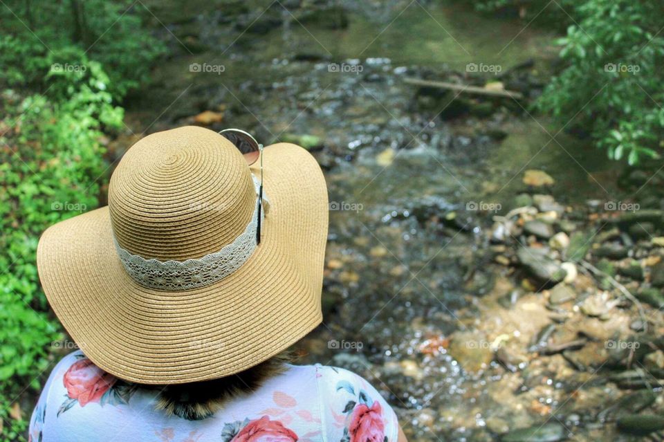A woman overlooking a stream