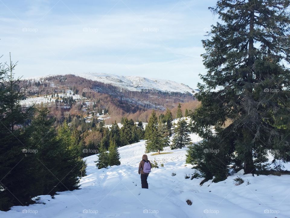 Woman hiking in the mountains in winter