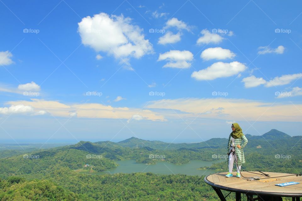 Female hiker wearing hijab looking at view