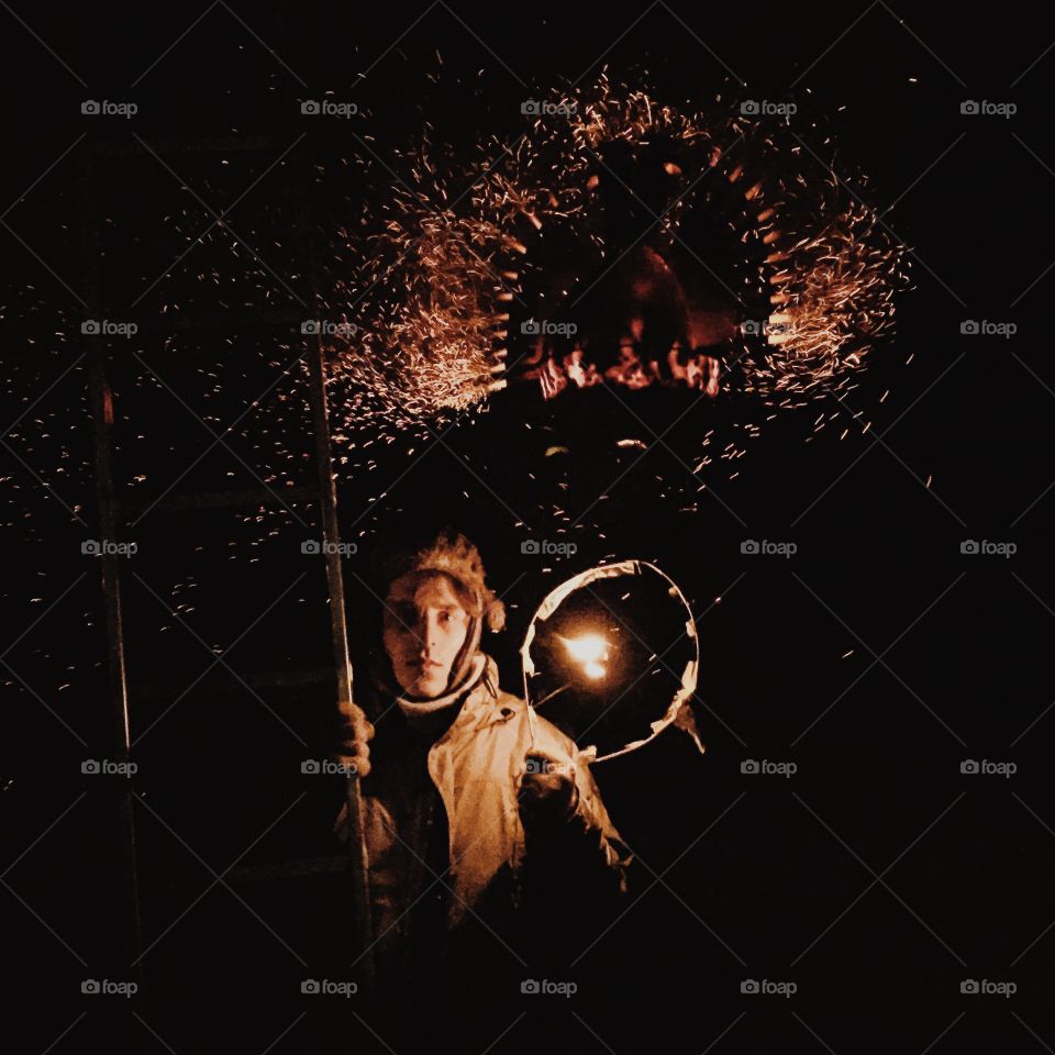 Man in a dark with stair and fire in hand, fire background, occult, esoteric, ritual 
