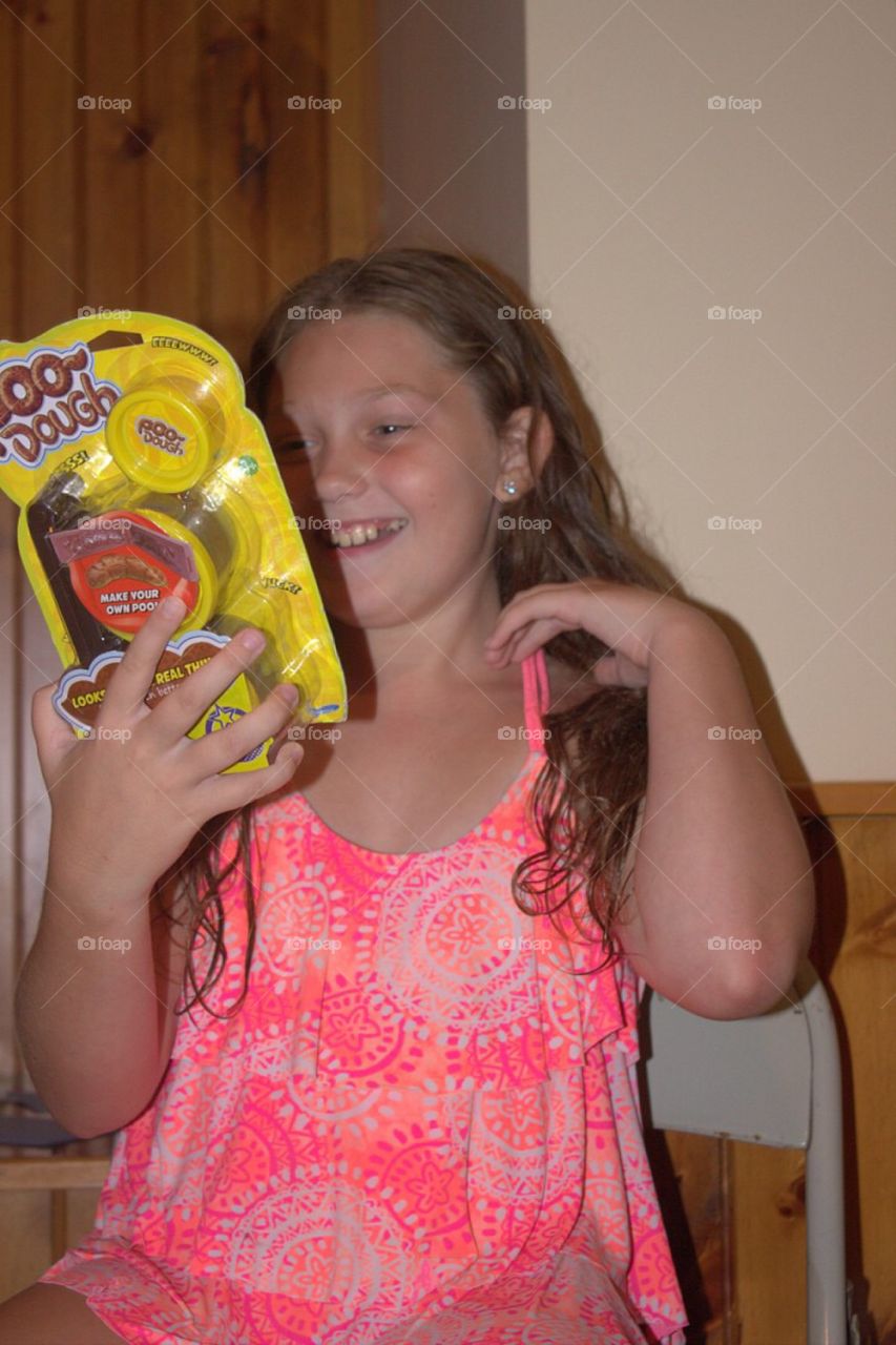 Smiling girl holding poo dough