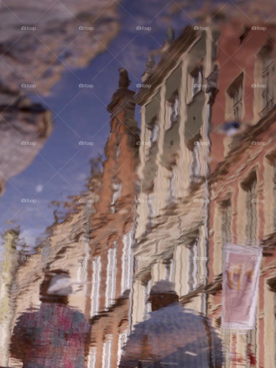 Reflection of two people taking a walk in Gdansk