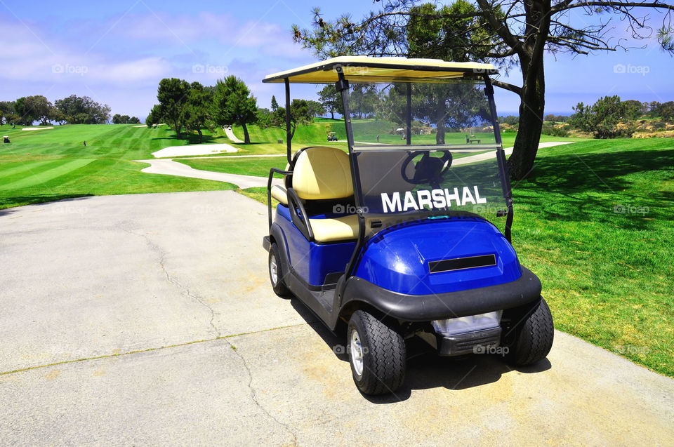 Golf course marshals golf cart.