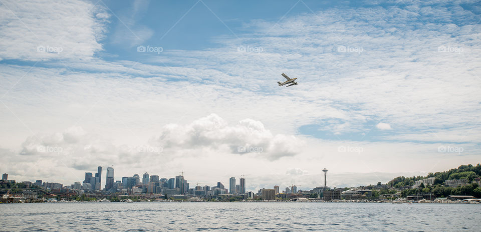 Seaplane takeoff in lake union. A seaplane lifts off in Lake Union with the Seattle skyline in the background. 