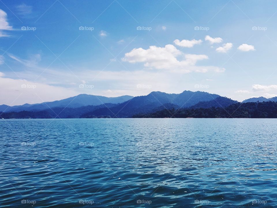 Scenic view of blue lake against sky
