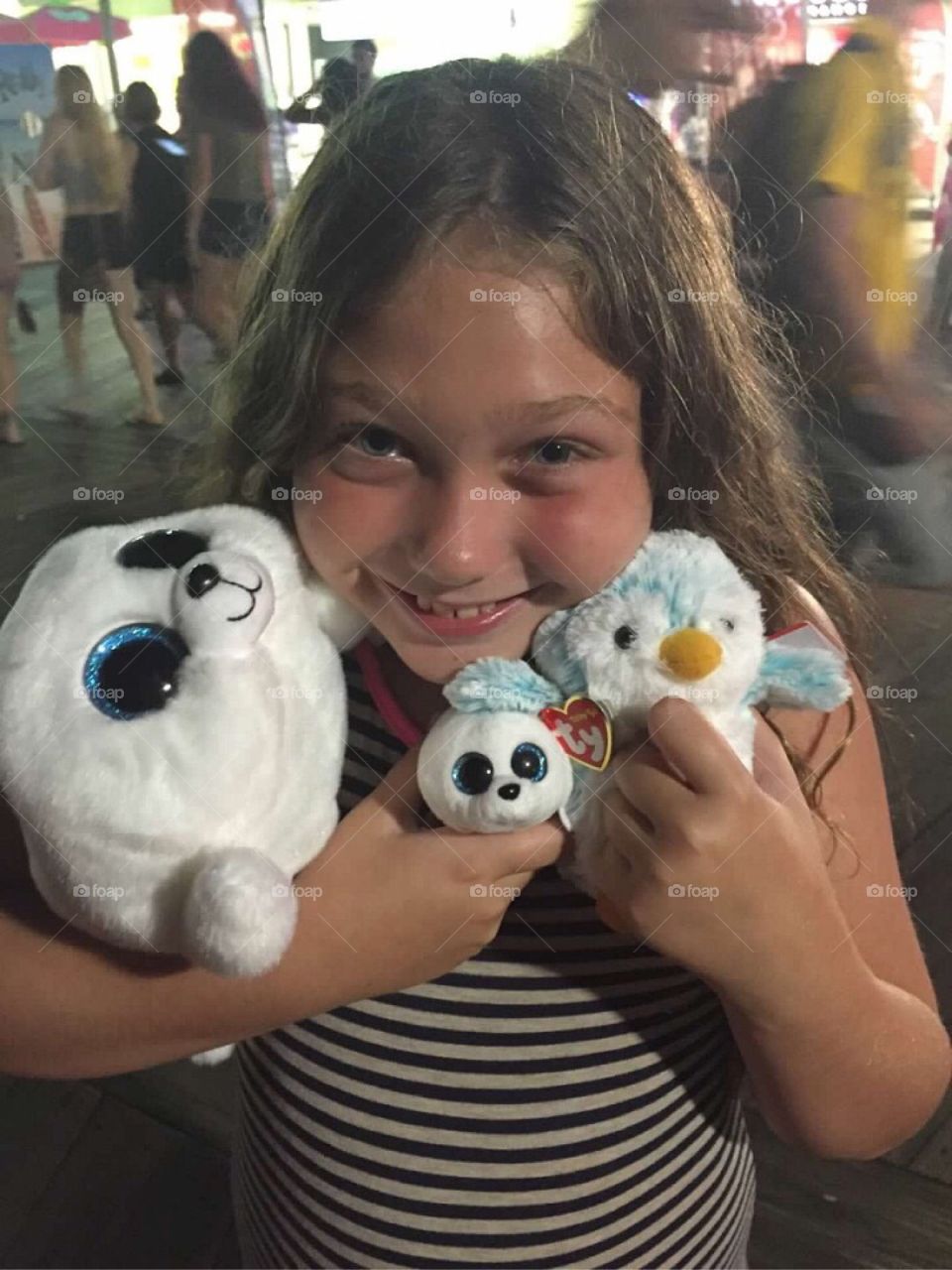 Smiling girl playing with soft toys