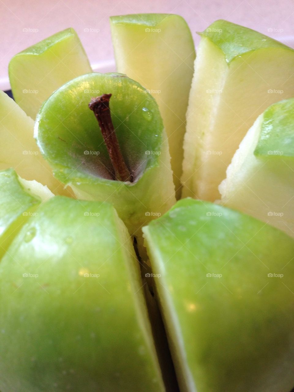 Green apple in an apple slicer