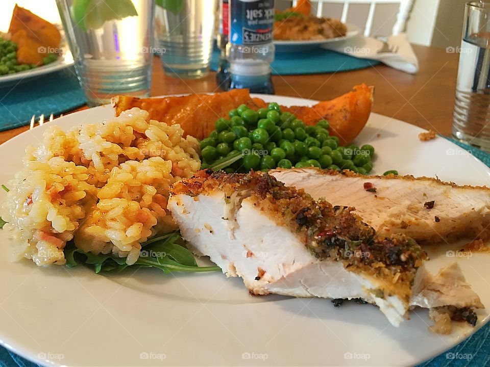 Mushroom risotto over arugula (rocket) and grilled chicken breast, with maple syrup glazed butternut squash pumpkin, and minted peas sides