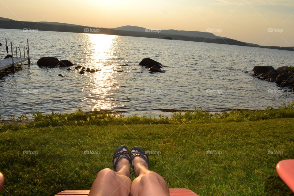 Relaxation in the glow. Relaxation at the lake in the golden glow of sunset