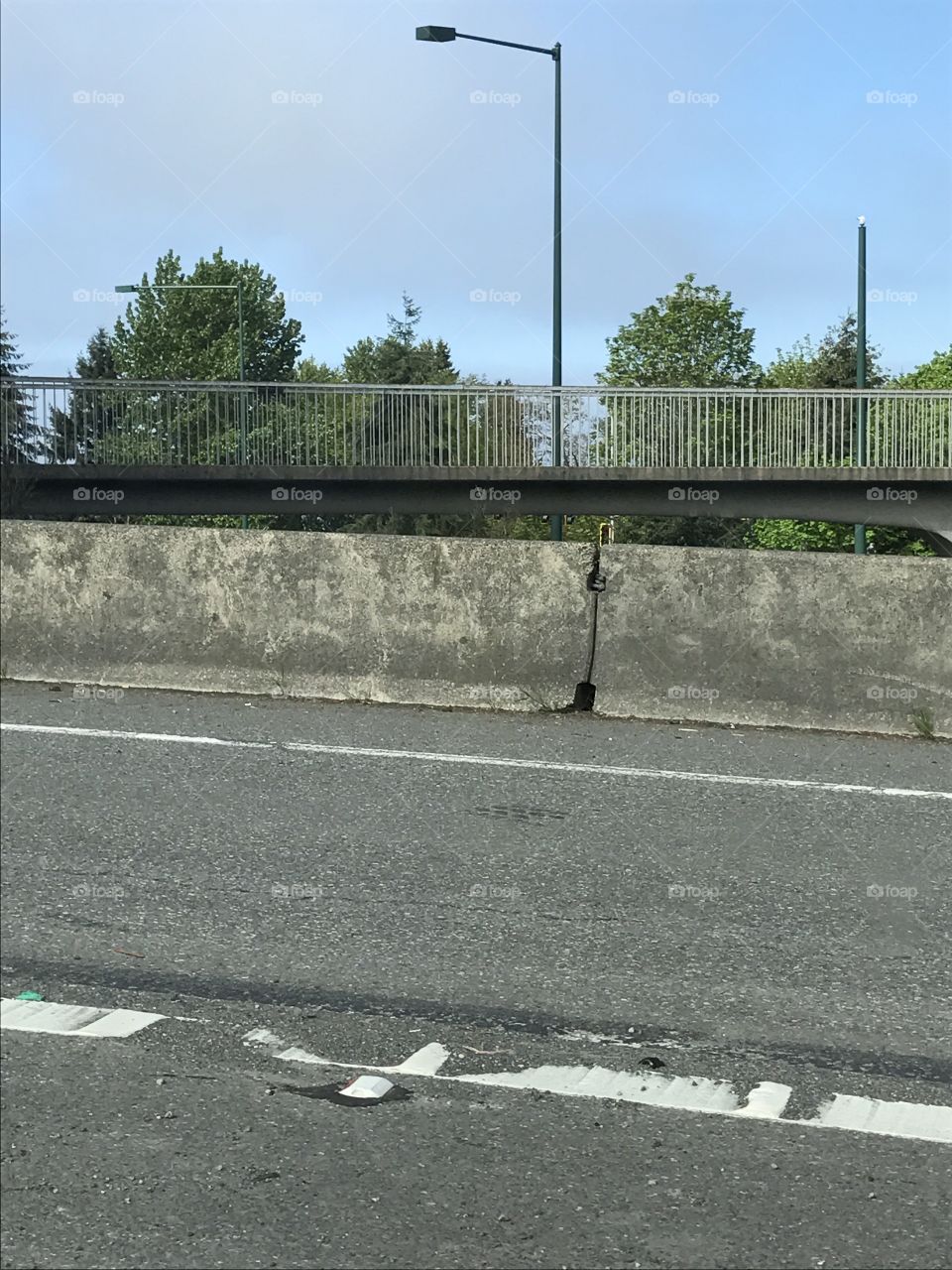 On the road with a bridge suspended in the background.