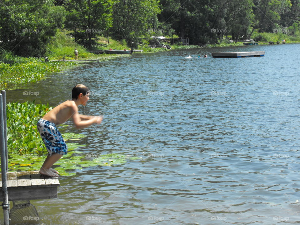 Boy about to jump in a lake