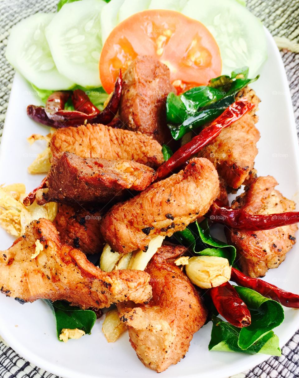 Fried pork with herbs and vegetables