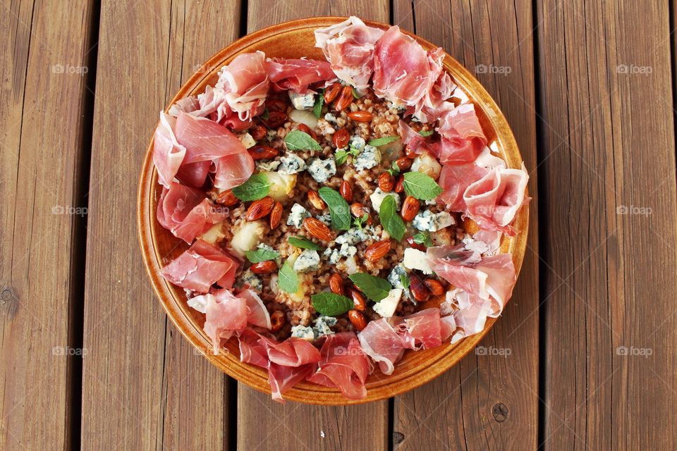 A plate with salad on wooden table