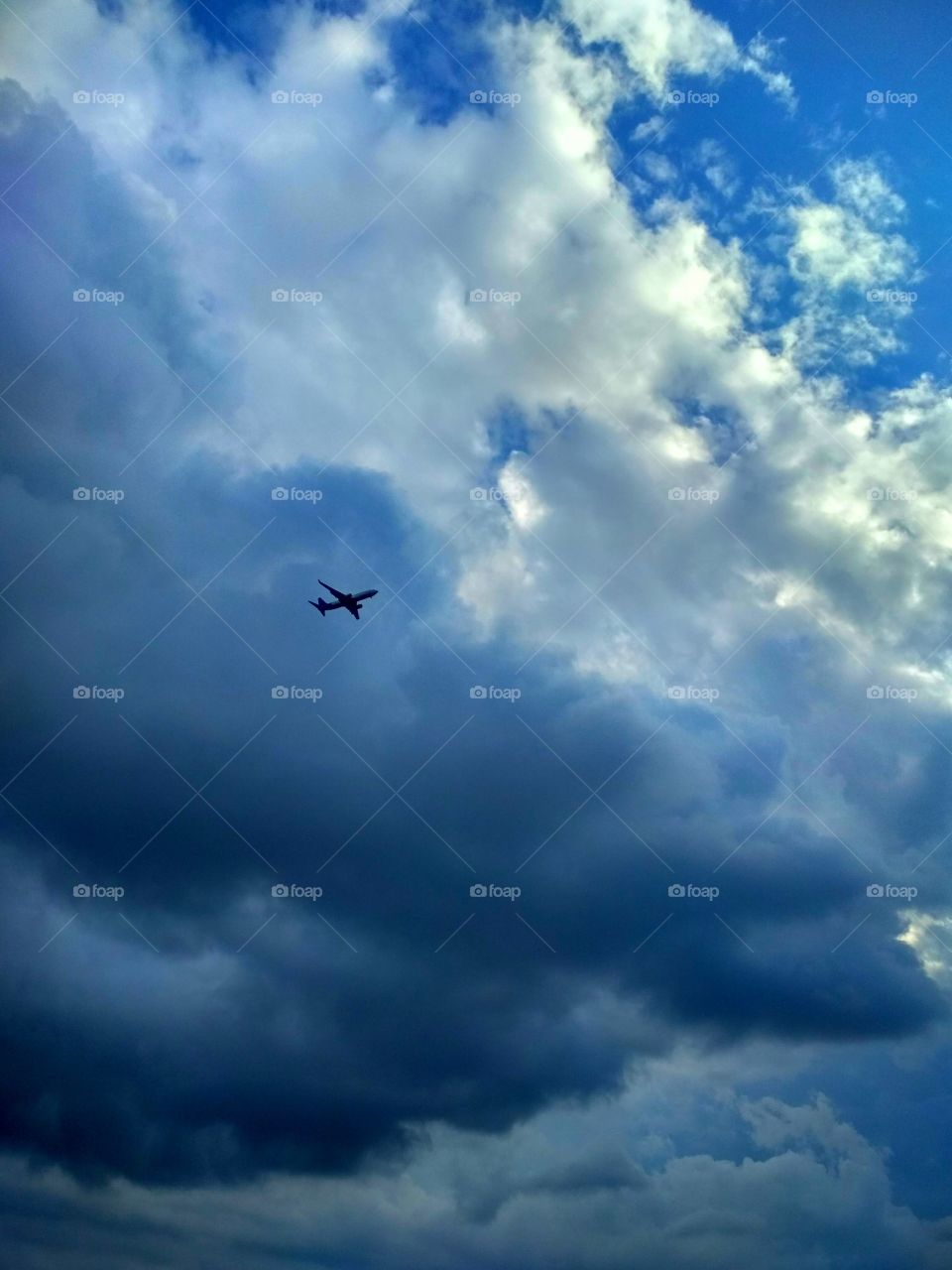 A plane over the rain clauds