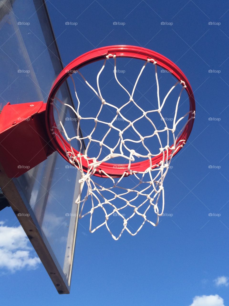 Outdoor basketball hoop on clear day 