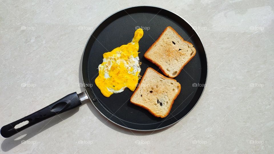 Egg omelette with bread toast in a pan, home made simple breakfast, healthy egg recipes, egg dishes
