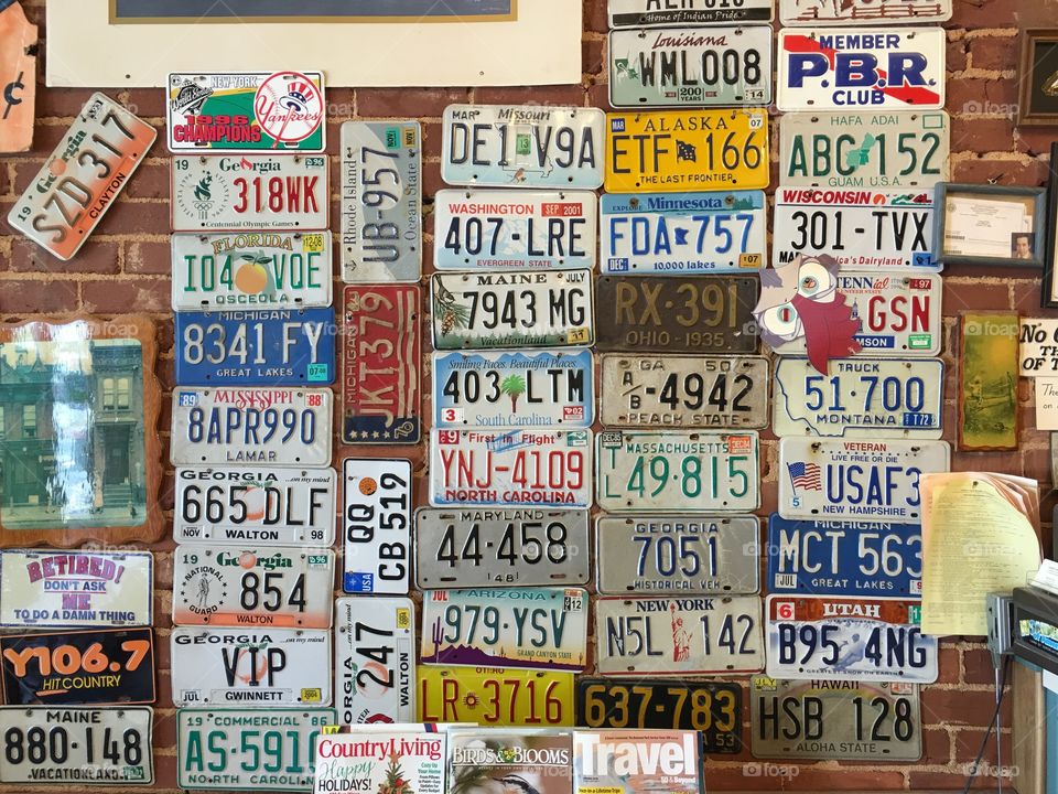 Vintage Barbershop in Monroe Georgia.  The barber has been cutting hair here for over 60 years.  These are the vintage car tags that hang in this barbershop. 