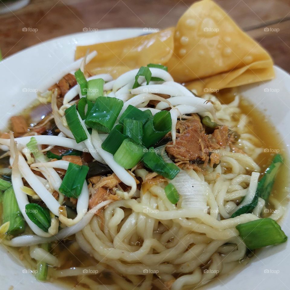 chicken noodles with spice sauce, chicken meat and bean sprouts