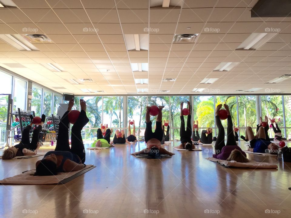 People doing Pilates class in gym