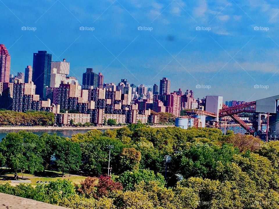 A view of Long Island City, Queens, NY while driving towards Forest Green, Brooklyn in a car on the highway on a beautiful clear summer day. The water of the East River can also be seen. 2020. Hypnotic Productions