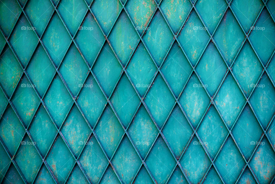 Rusty colored metal with cracked paint, grunge background. Blue and green color tones