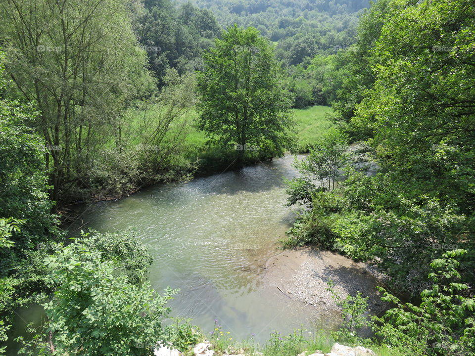 River bends im the field Sun reflection on it's surface
