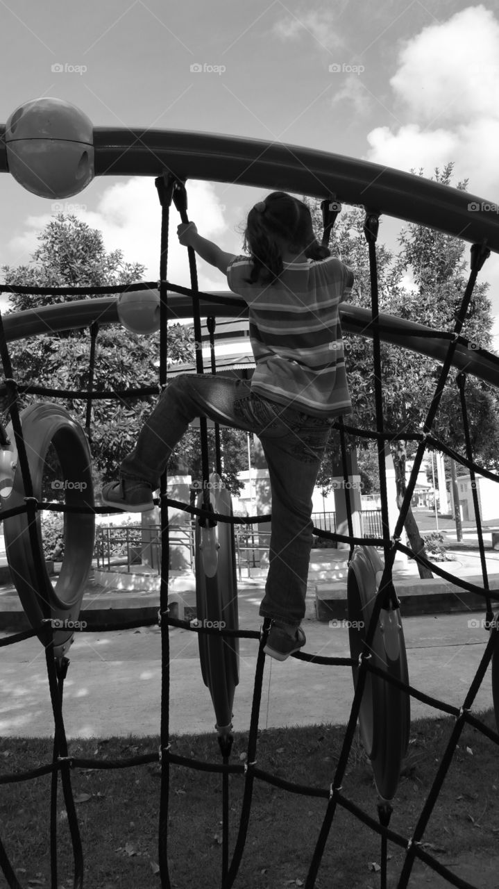 Girl climbing a Web at a playground