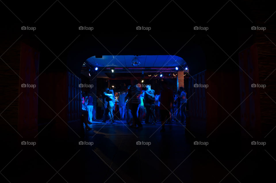 people dancing in the night club, photo taken from behind 