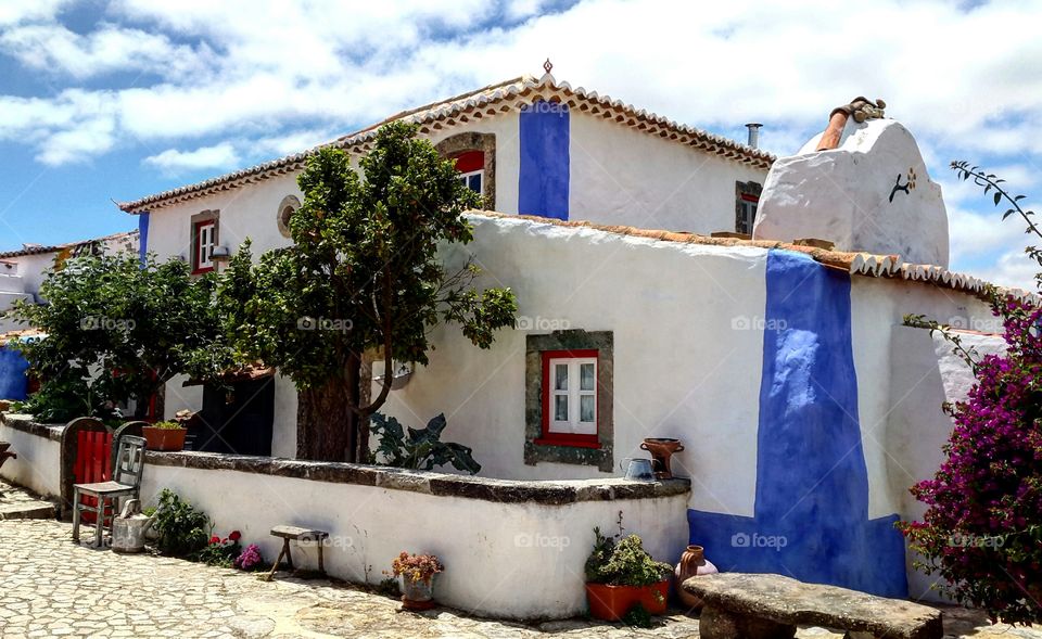 A traditional portuguese rural house, white washed and trimmed with the blue to ward off evil spirits, a legacy left by the Moors.