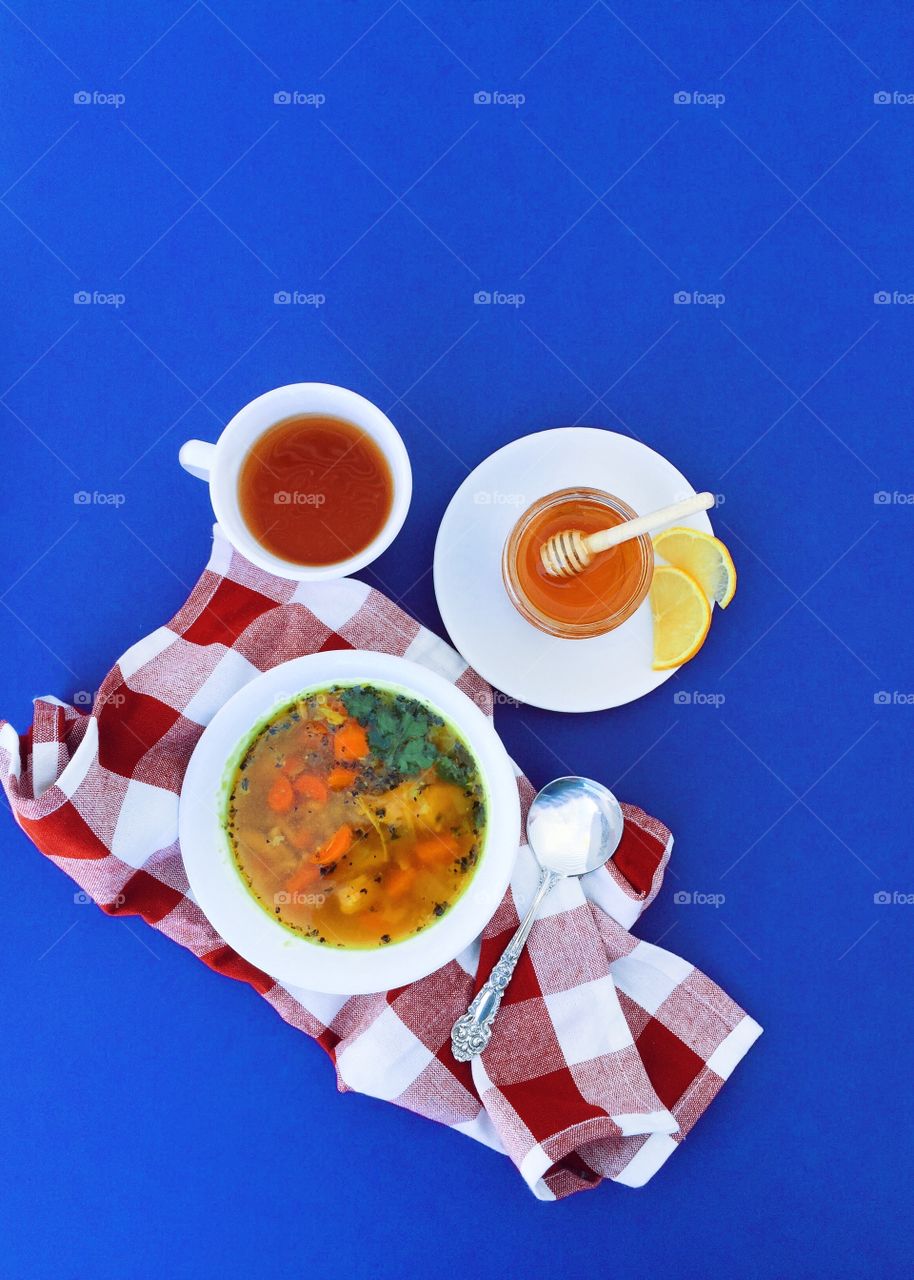 High angle view of tea and soup on blue background