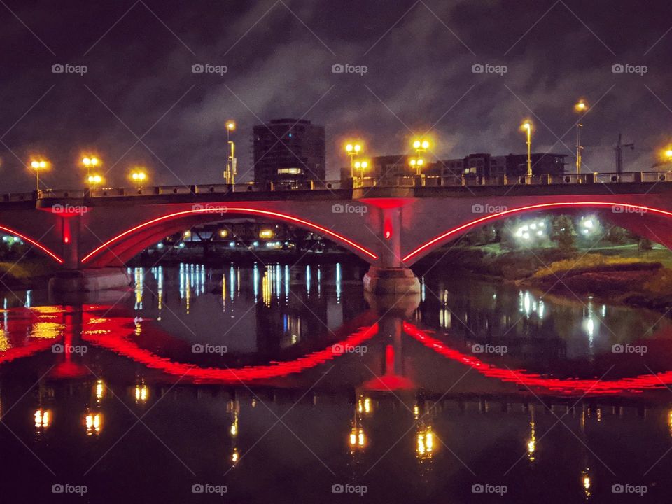 city nightscape water bridge red clouds night time