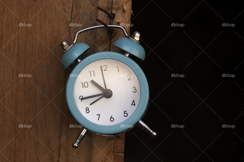 Blue clock on brown black background