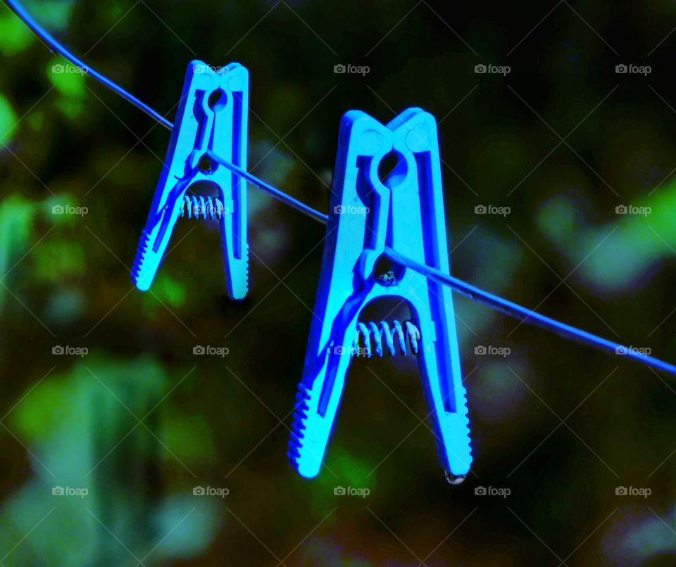 Two blue clothespins