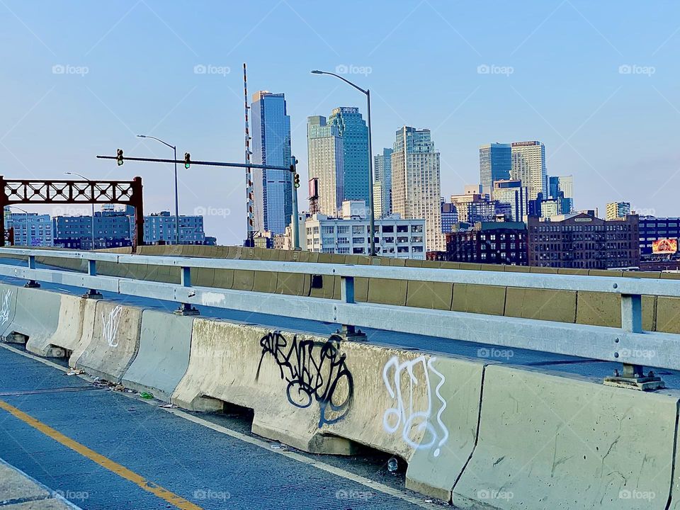 This is another impression of the famous “Pulaski Bridge” at “Newtown Creek” in LIC, Queens with graffiti on the barrier that separates the bicycle from the car lane. 2023. Hypnotic Productions