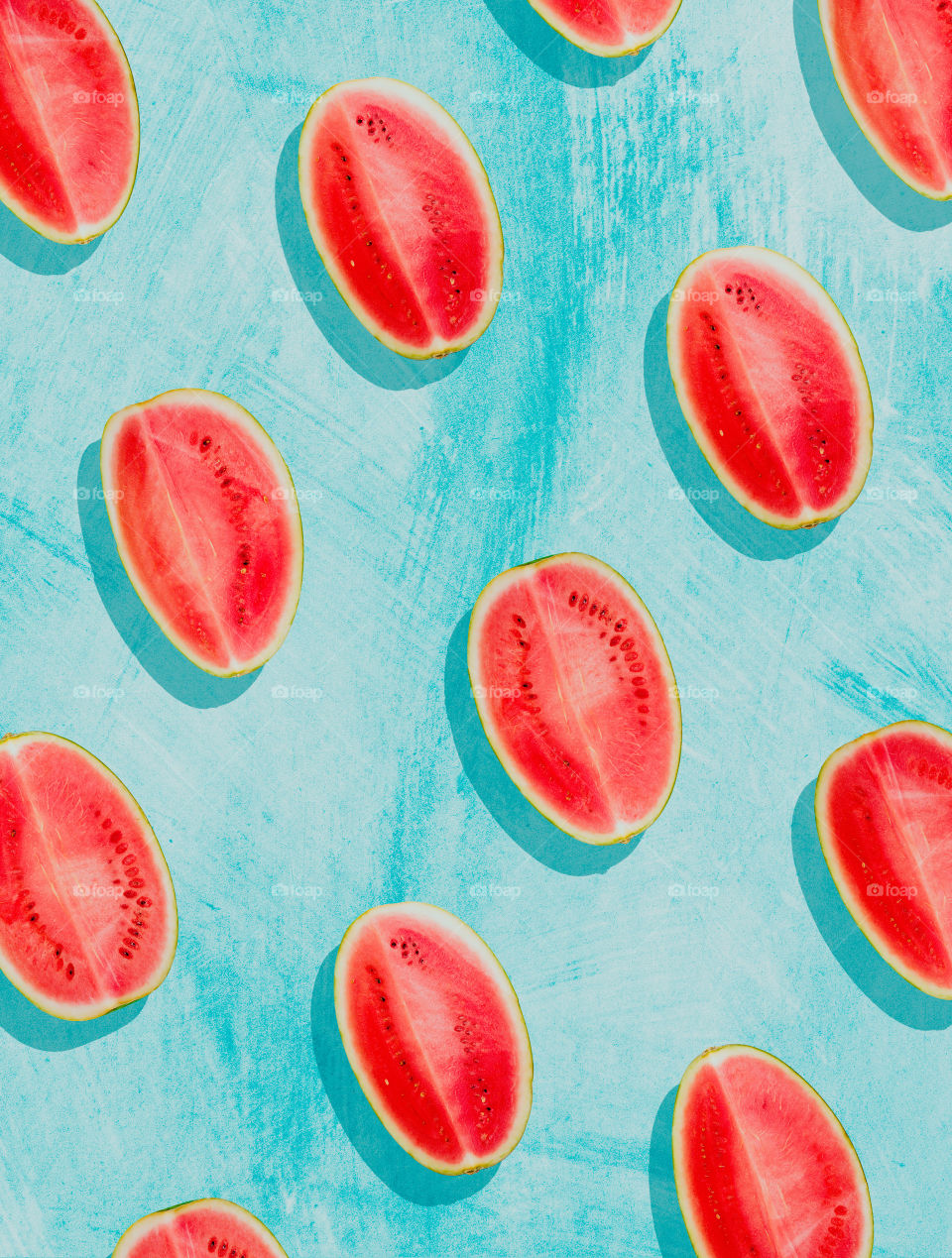 Watermelon pattern. Slices of watermelon on a surface painted in bright blue