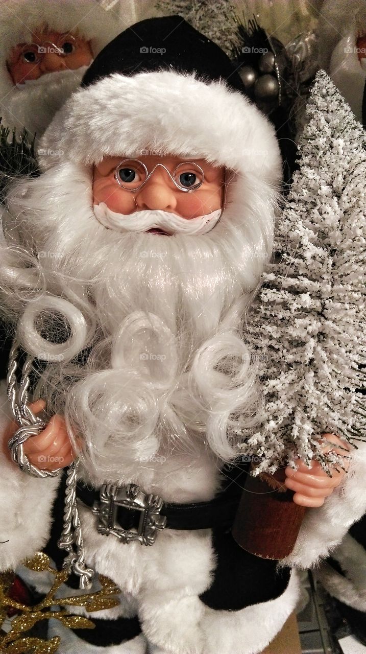 Santa Claus holding christmas tree