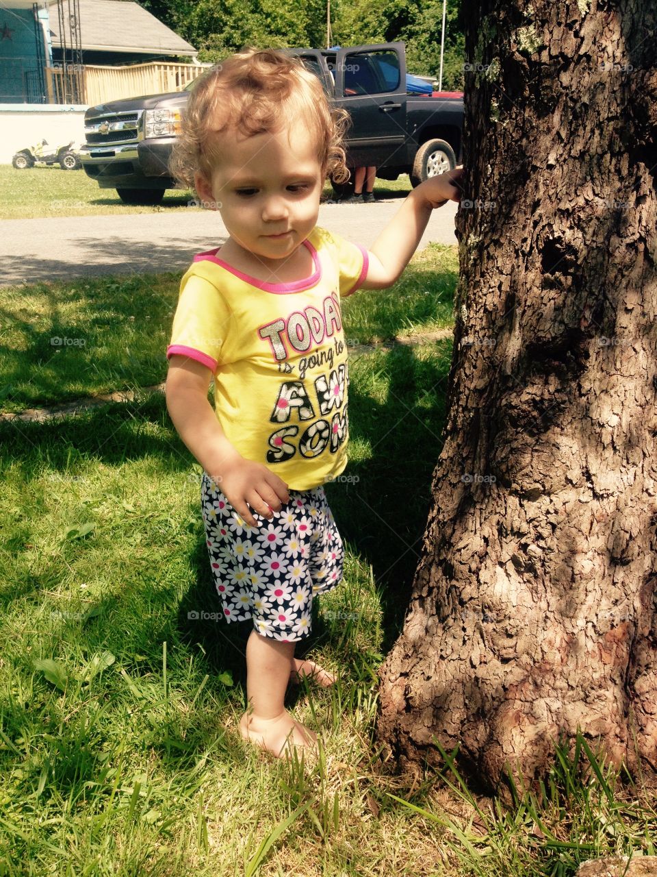 Toddler Standing by Tree