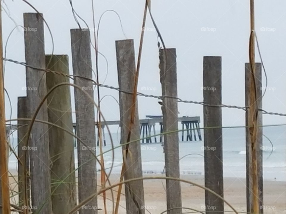 Pier seen through fence