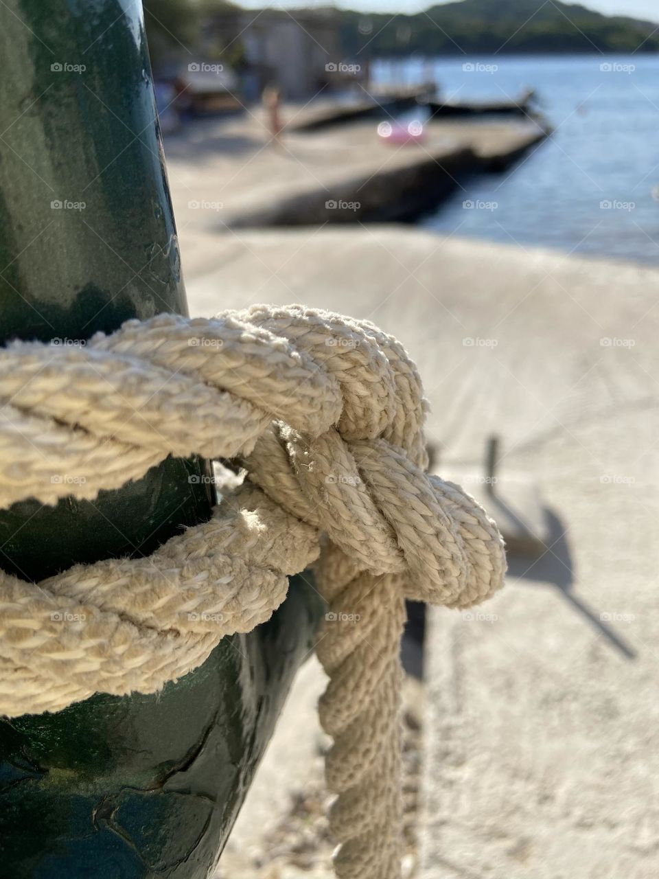 Nautical rope knot by seaside.