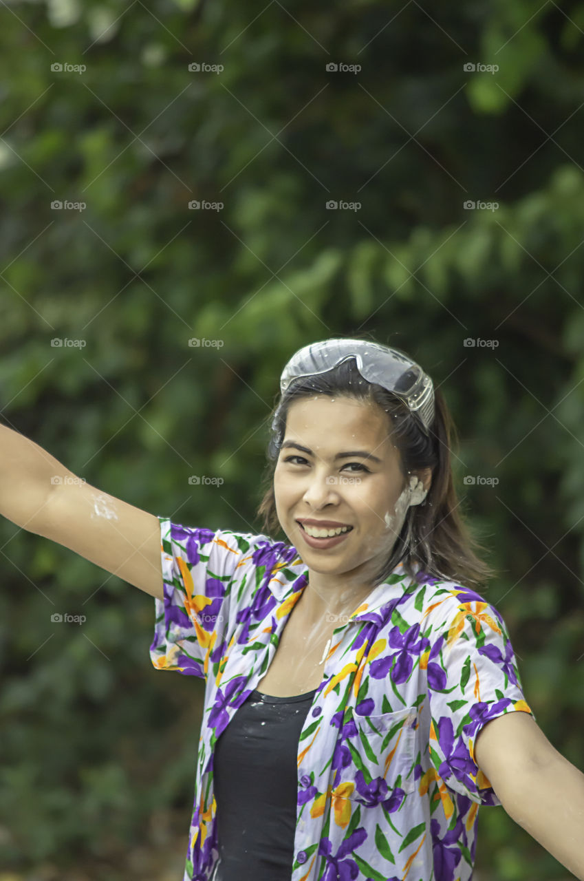 Asian woman play water and flour in Songkran festival or Thai new year in Thailand.