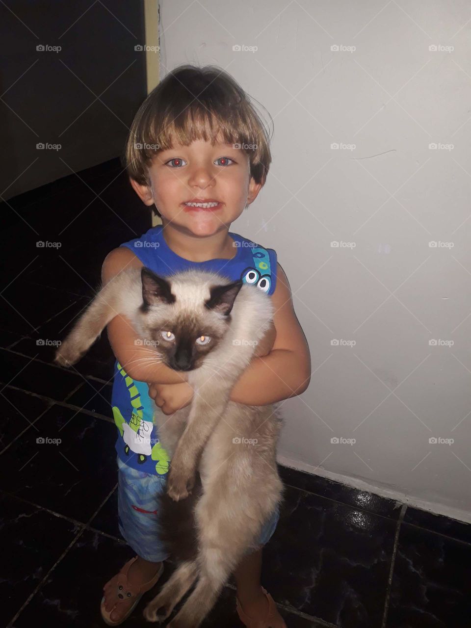 pretty child playing with the kitten