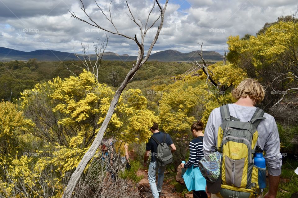 Family hike in the south Australian outback and Flinders Ranges coming down a mountain with backpacks 