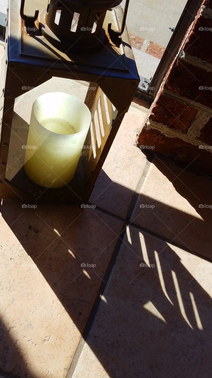 shadows from outdoor hurricane lamps