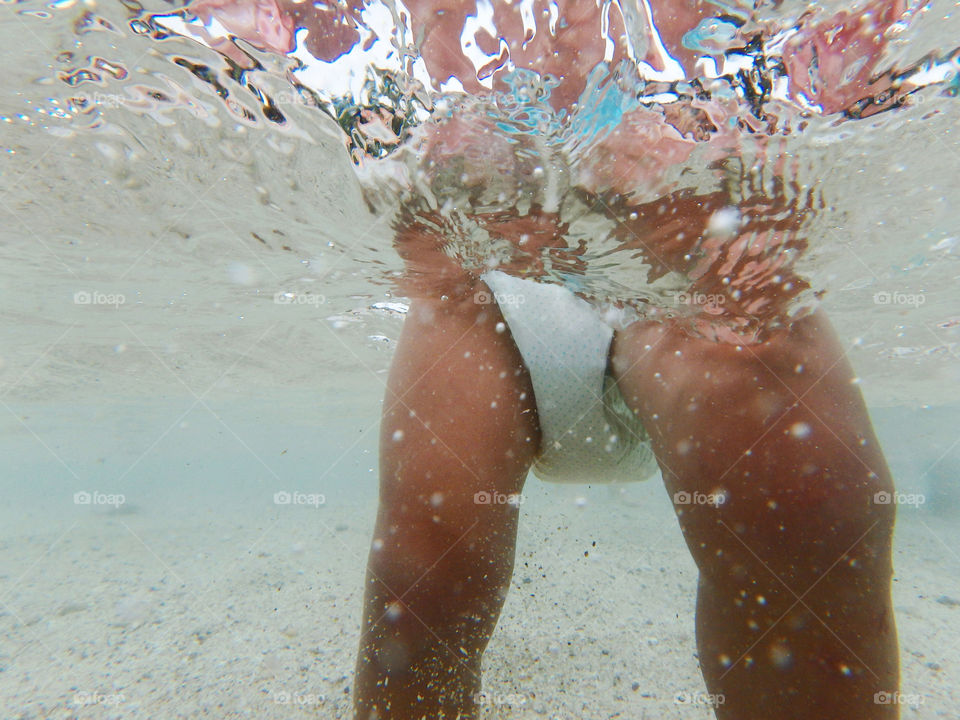 baby underwater. baby with diapers in clean sea underwater