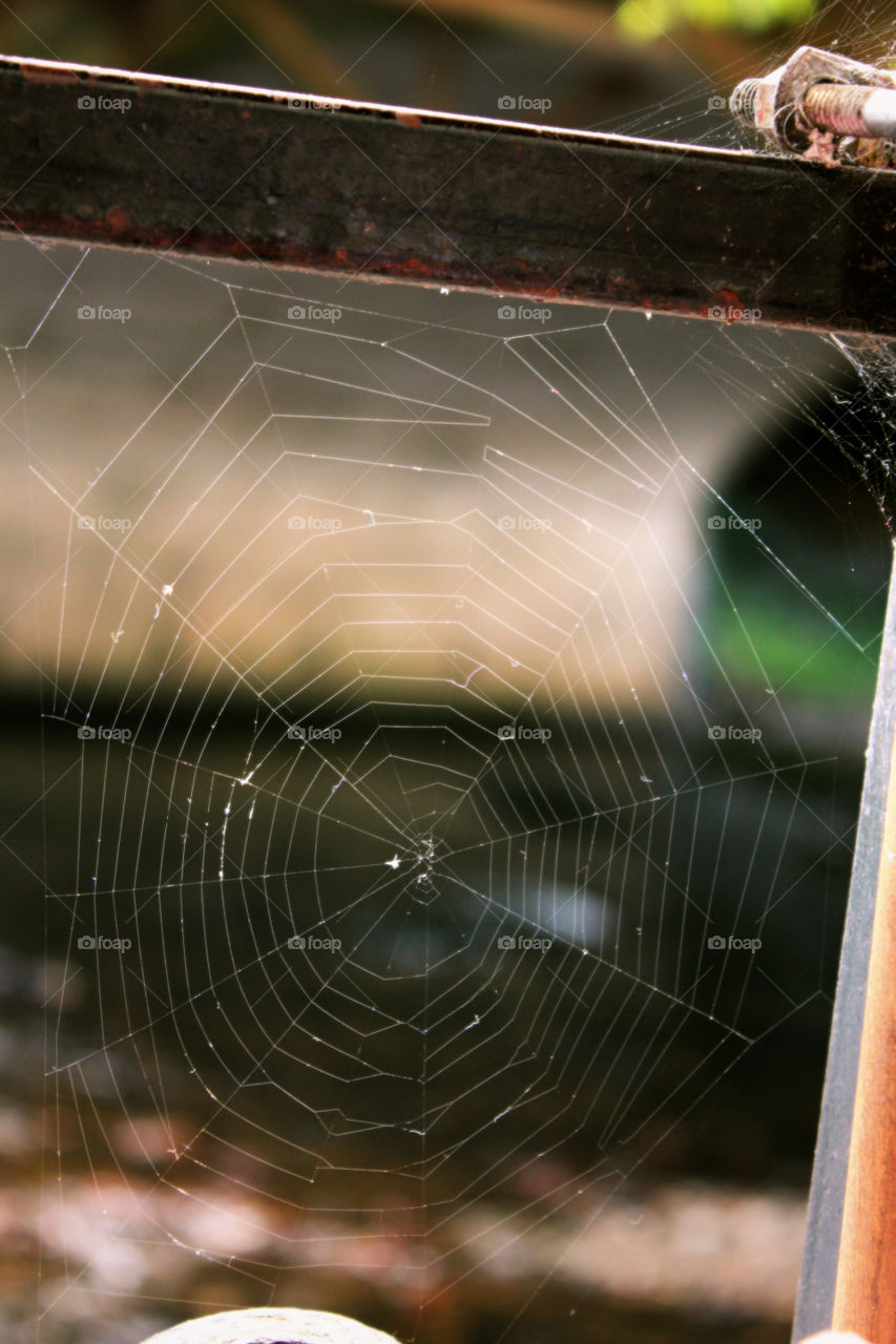 Spiderweb in Helen. Spiderweb between a railing in Helen, GA