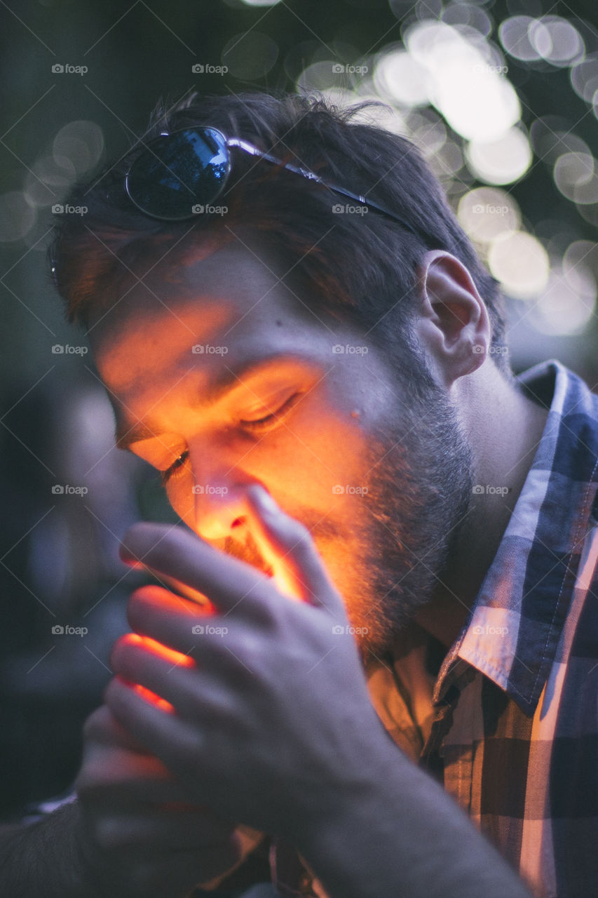 Close-up of a man lighting his cigarette